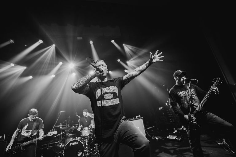 Black and white photo of a band performing live on stage under bright concert lights during 618 Fest.